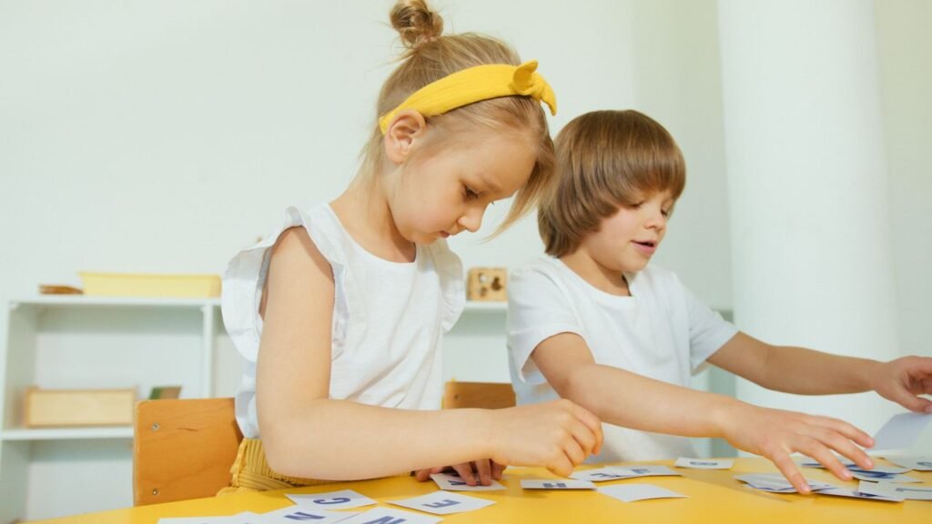 Mastering the First Impression: Your intriguing post title goes here Two young children engaged in a fun learning activity indoors, focusing on letters.