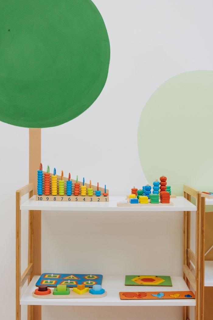 A well-organized indoor playroom filled with colorful educational toys for preschool children.